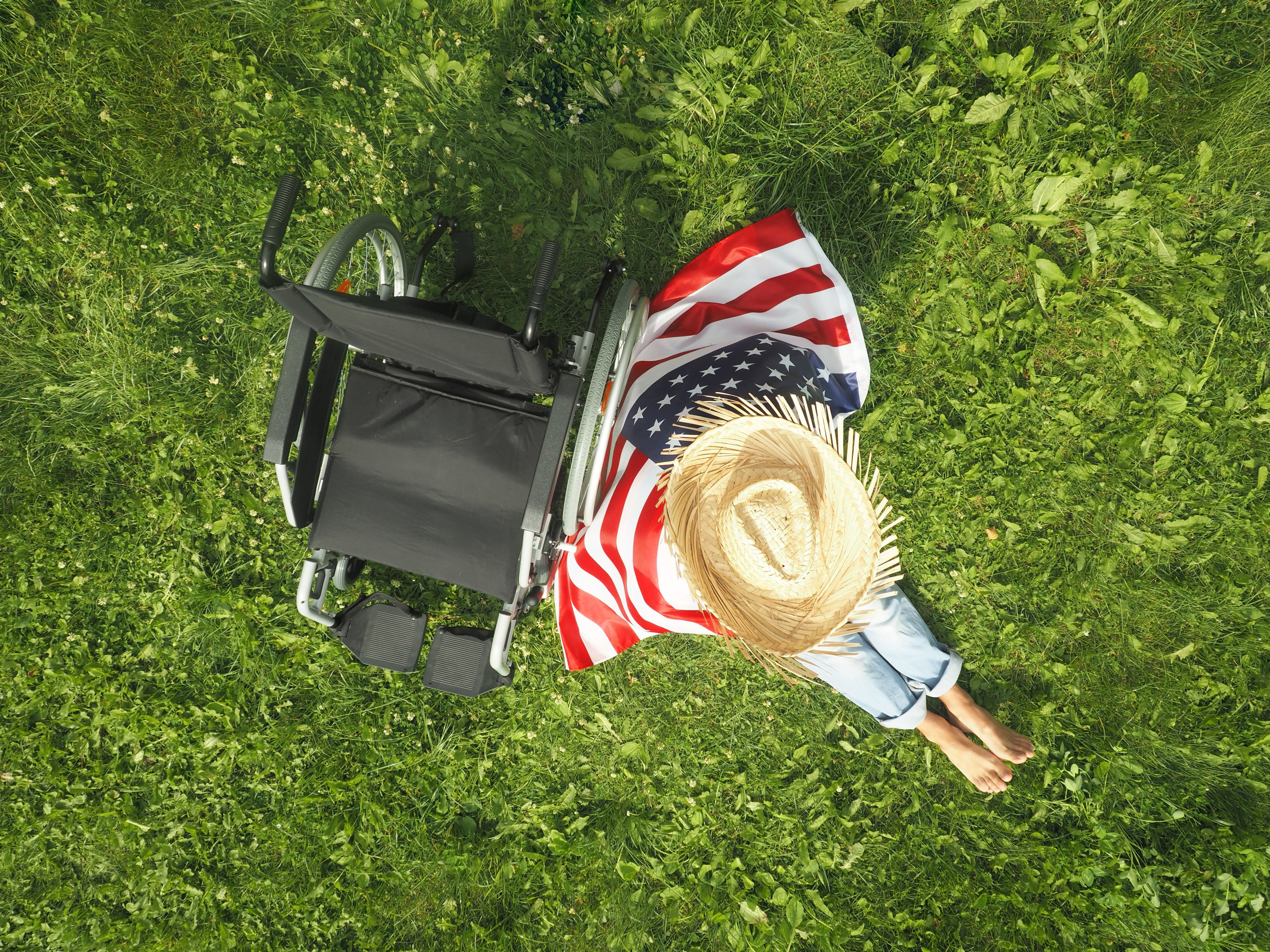 A wheelchair user celebrates the Fourth of July with an American flag