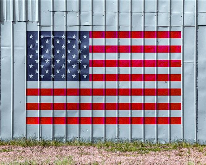 An American flag on the side of a factory